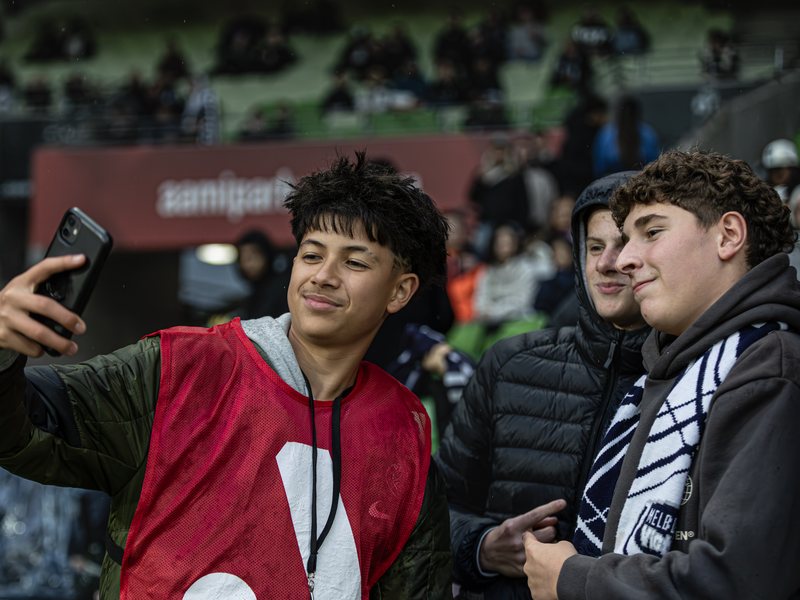 Guillaume Castillo taking a selfie with young fans in the stands