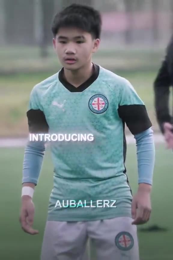 Young player in a sky blue training top looking at the camera